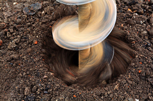 A drill digging a hole