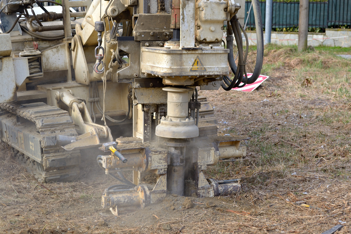 A white geotechnical drill drilling into El Paso soil.